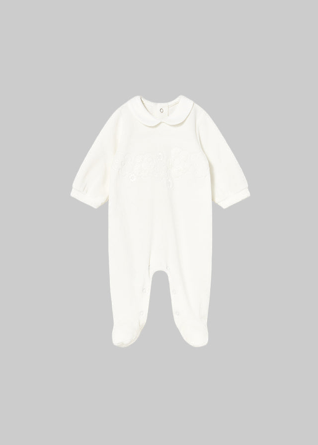 White baby onesie on a light gray background