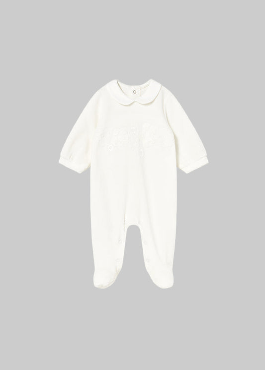 White baby onesie on a light gray background